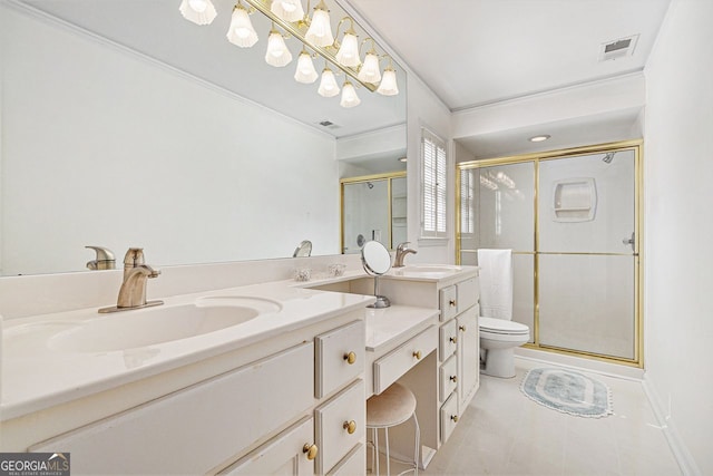 bathroom featuring double vanity, a shower stall, toilet, and a sink