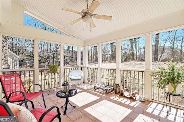 sunroom / solarium featuring ceiling fan and vaulted ceiling