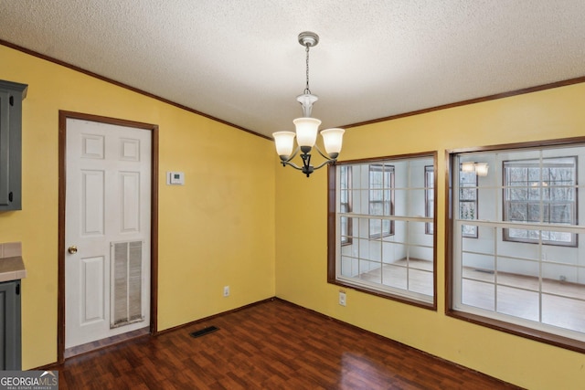 unfurnished dining area featuring vaulted ceiling, dark hardwood / wood-style flooring, a notable chandelier, crown molding, and a textured ceiling