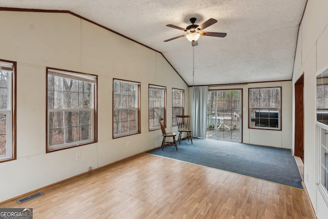 unfurnished sunroom with lofted ceiling and ceiling fan