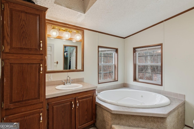 bathroom with vaulted ceiling, vanity, tiled tub, crown molding, and a textured ceiling