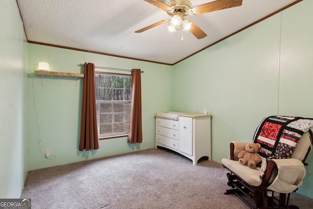 unfurnished room featuring crown molding, ceiling fan, carpet, a textured ceiling, and vaulted ceiling