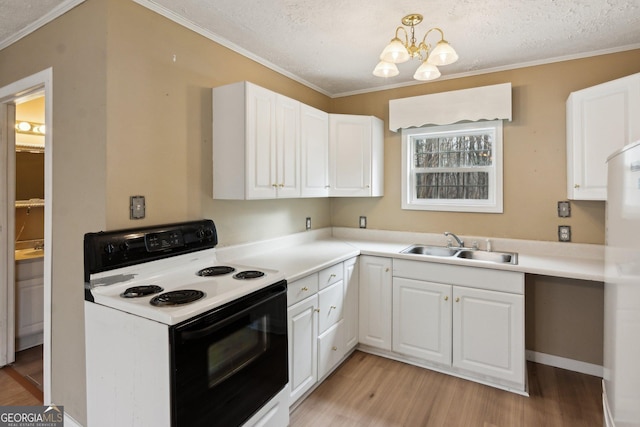 kitchen featuring white cabinetry, sink, white fridge, and electric range