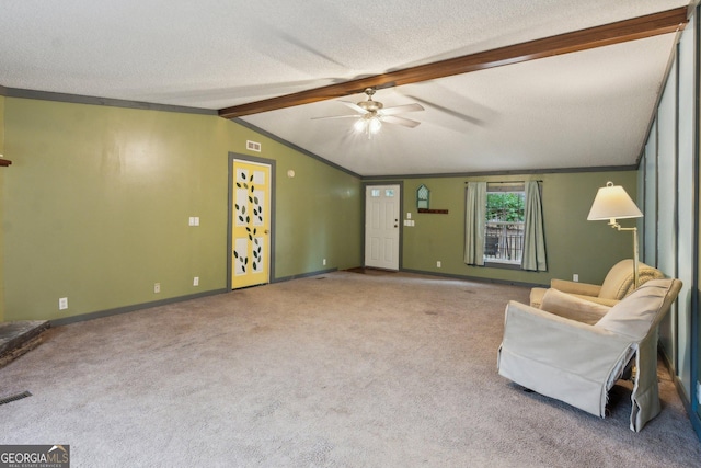 sitting room featuring vaulted ceiling with beams, ornamental molding, a textured ceiling, and carpet