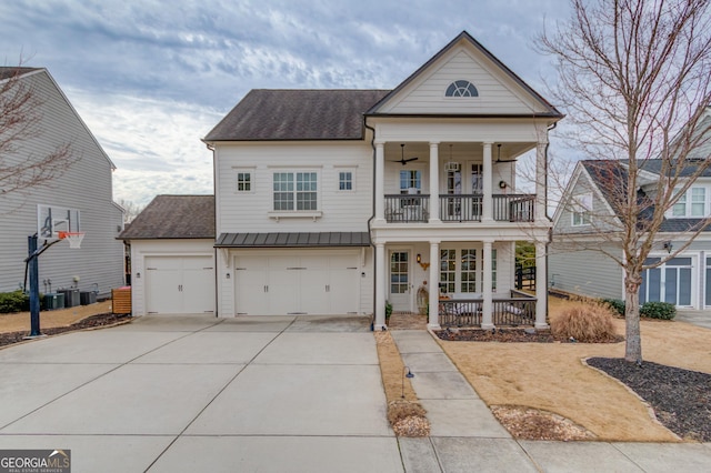 view of front of house featuring cooling unit, a garage, a balcony, and covered porch