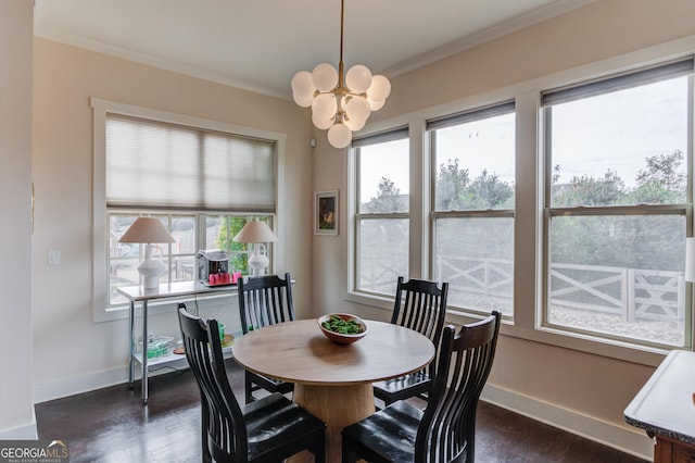 dining area with ornamental molding, dark hardwood / wood-style flooring, and a chandelier