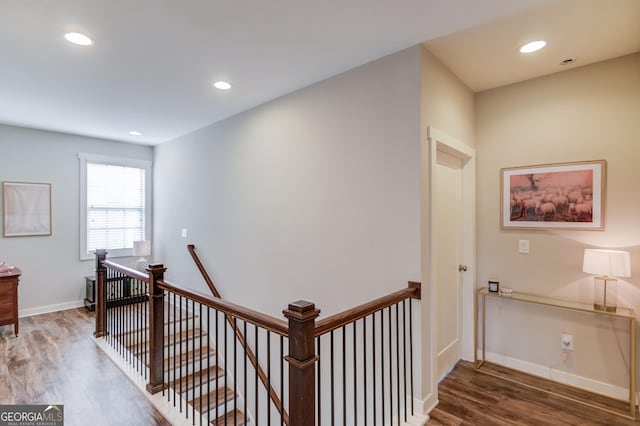 corridor with dark hardwood / wood-style flooring