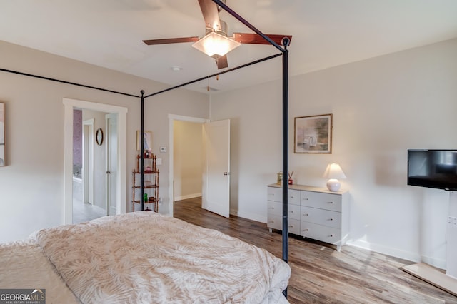 bedroom with ceiling fan and hardwood / wood-style floors