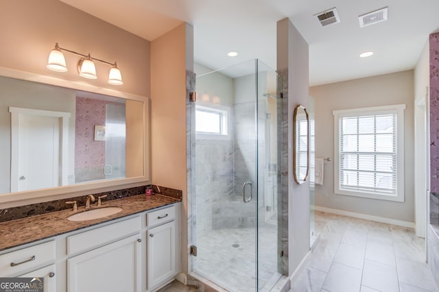 bathroom with vanity, a shower with shower door, and tile patterned floors