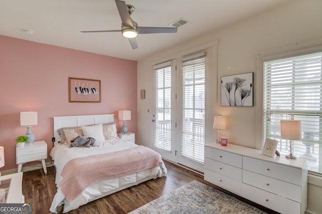 bedroom with dark hardwood / wood-style floors, access to exterior, and ceiling fan