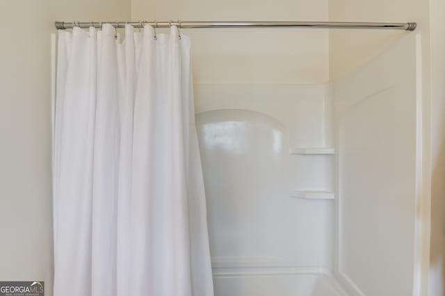 bathroom with a shower with shower curtain