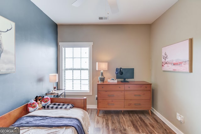 bedroom featuring hardwood / wood-style floors and ceiling fan