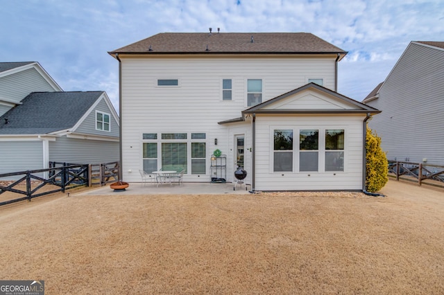 rear view of house with a yard and a patio area