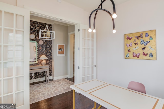 dining space with hardwood / wood-style floors and french doors