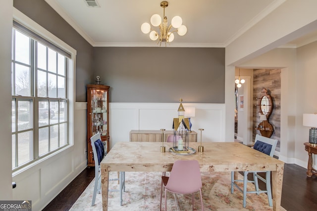 dining area featuring a notable chandelier, crown molding, and dark wood-type flooring