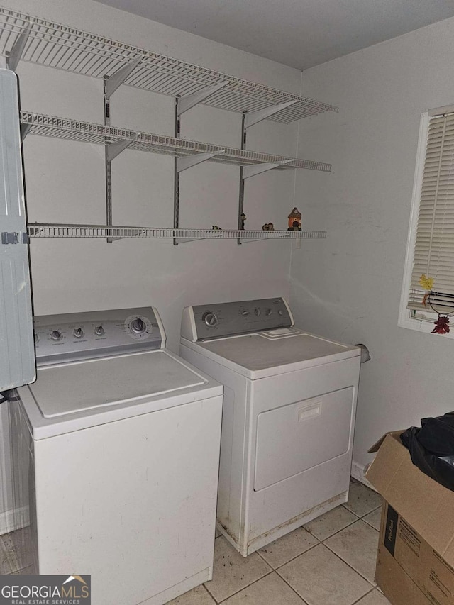 laundry area with light tile patterned flooring and independent washer and dryer