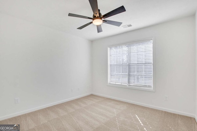 carpeted empty room featuring ceiling fan