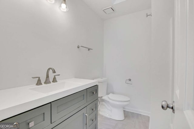 bathroom with vanity and toilet