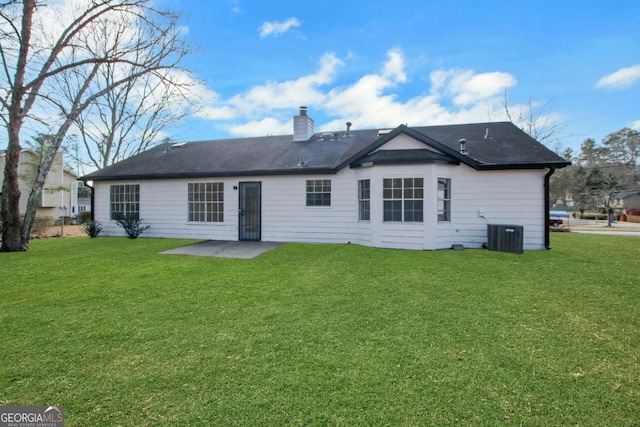 back of house featuring cooling unit, a yard, and a patio area