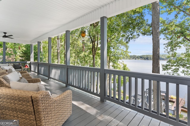 wooden terrace featuring a water view and ceiling fan