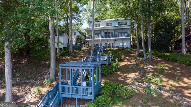 rear view of property with a balcony