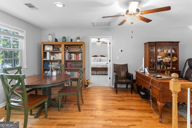 dining area with ceiling fan and light hardwood / wood-style floors