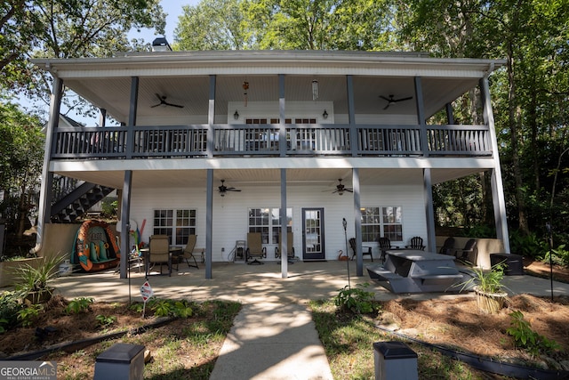 back of property featuring ceiling fan and a patio area