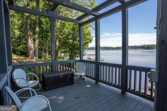 sunroom / solarium with a water view