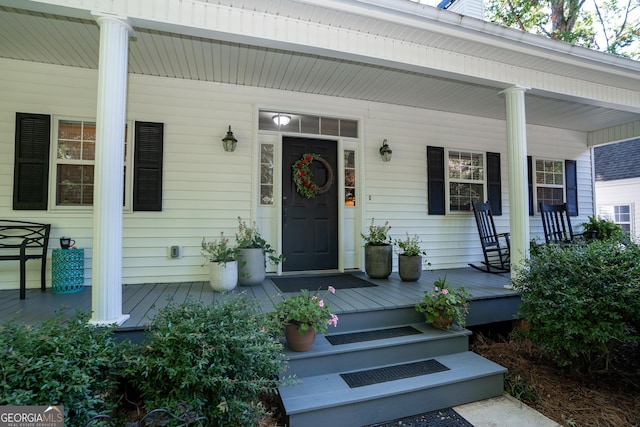 view of exterior entry with covered porch