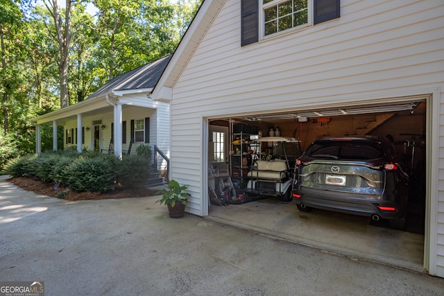 view of home's exterior with a porch and a garage