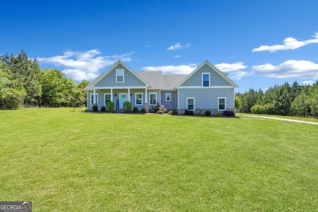 view of front of home featuring a front yard and covered porch