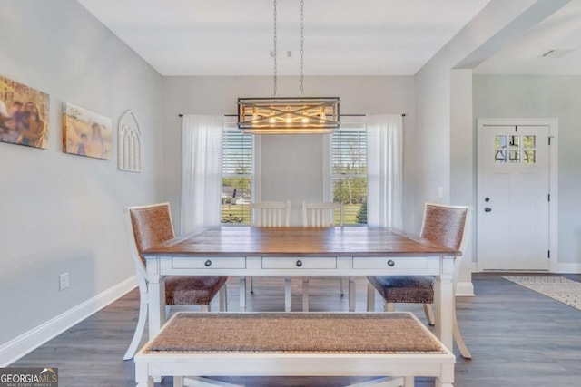 unfurnished dining area with dark wood-type flooring