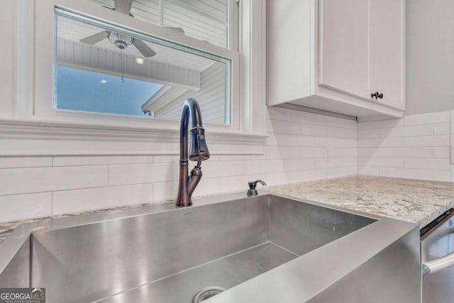 details with sink, ceiling fan, tasteful backsplash, light stone counters, and white cabinets