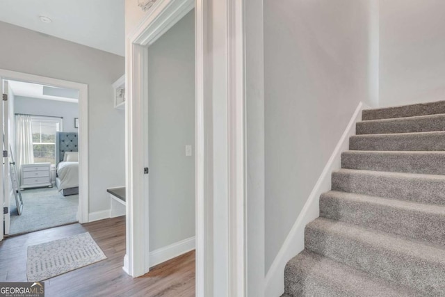 stairs featuring hardwood / wood-style flooring