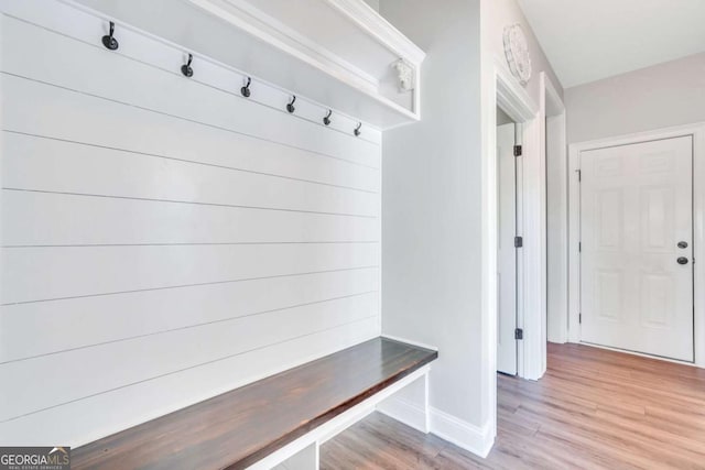 mudroom featuring track lighting and hardwood / wood-style floors