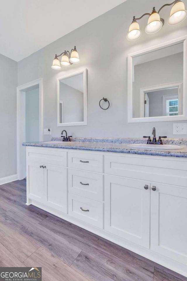 bathroom with vanity and hardwood / wood-style floors