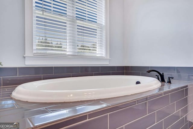 bathroom with tiled bath