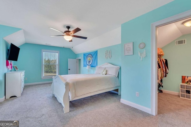 carpeted bedroom featuring ceiling fan and vaulted ceiling