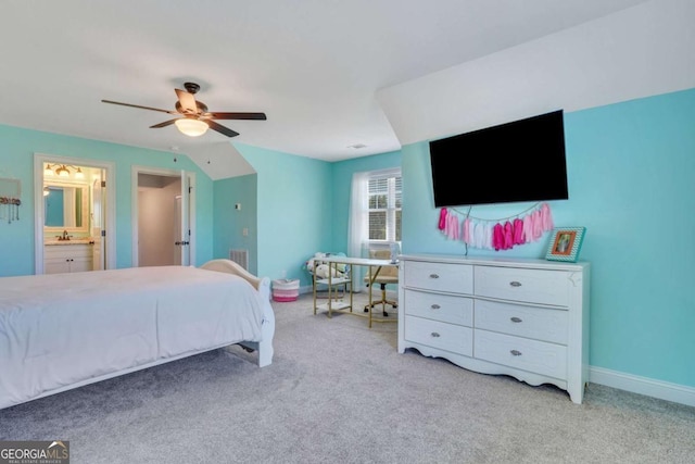 bedroom featuring ceiling fan, ensuite bath, sink, and light carpet