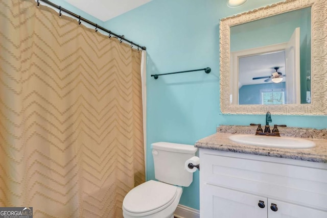 bathroom with vanity, toilet, and curtained shower