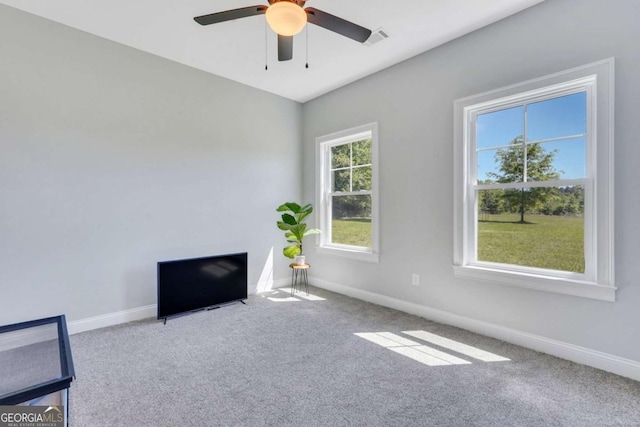 interior space featuring carpet floors and ceiling fan