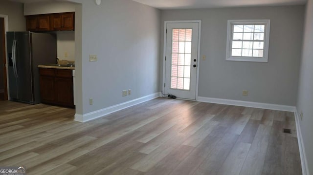 interior space featuring sink and light wood-type flooring