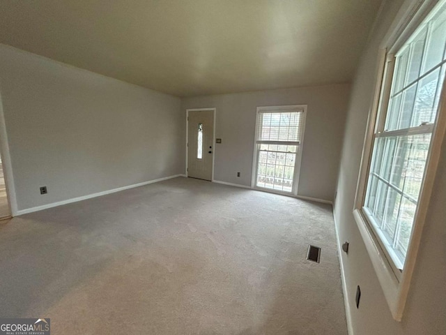 empty room featuring light carpet