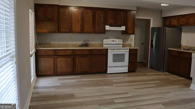 kitchen with white electric range oven, sink, stainless steel fridge with ice dispenser, dark brown cabinets, and light hardwood / wood-style flooring