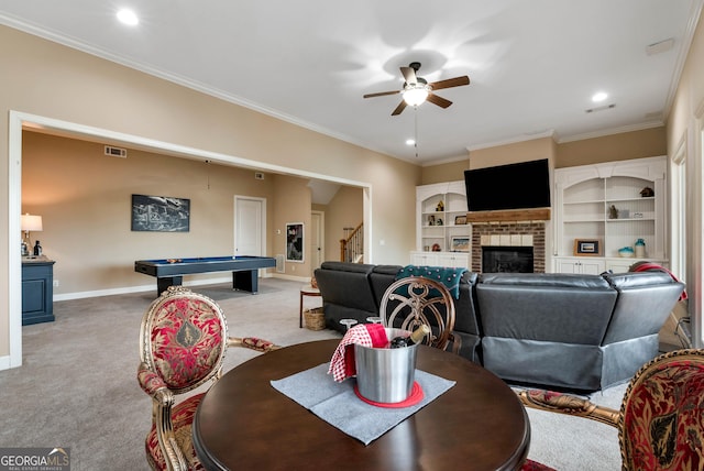 dining area with light colored carpet, ornamental molding, pool table, and a fireplace