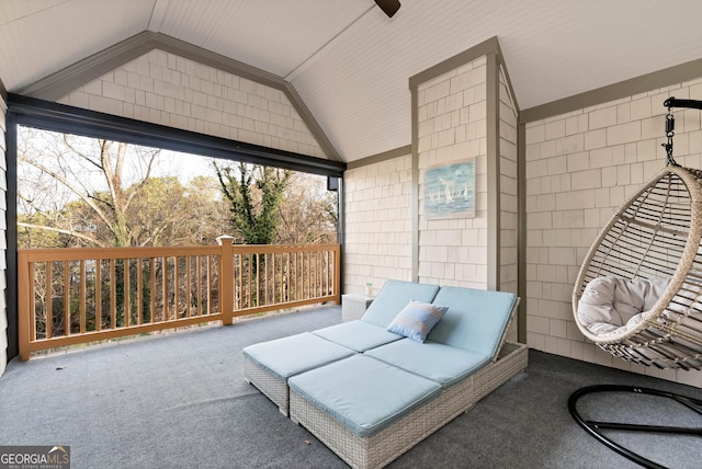 interior space featuring lofted ceiling, carpet flooring, and tile walls