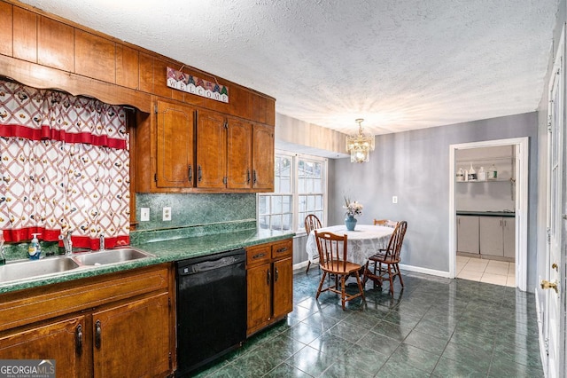 kitchen featuring sink, dishwasher, backsplash, a textured ceiling, and decorative light fixtures