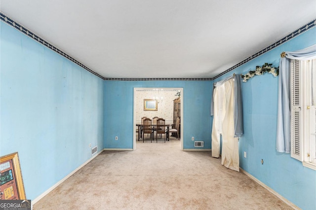 unfurnished room featuring carpet