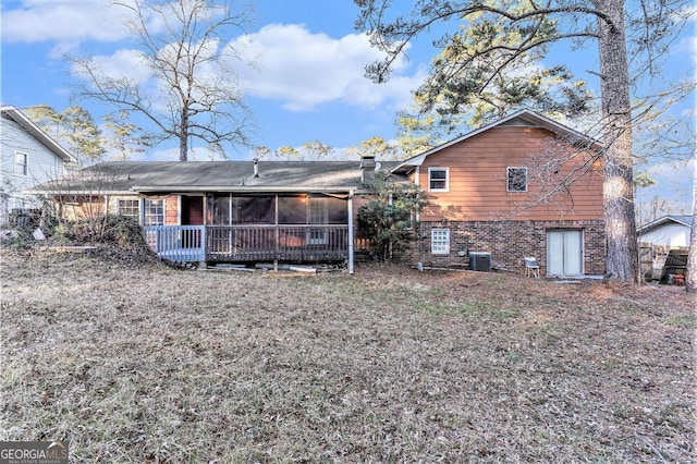 rear view of property with central AC and a sunroom