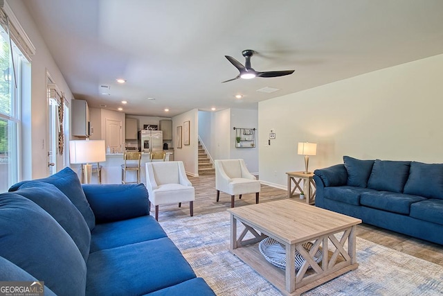 living room with ceiling fan and light hardwood / wood-style floors